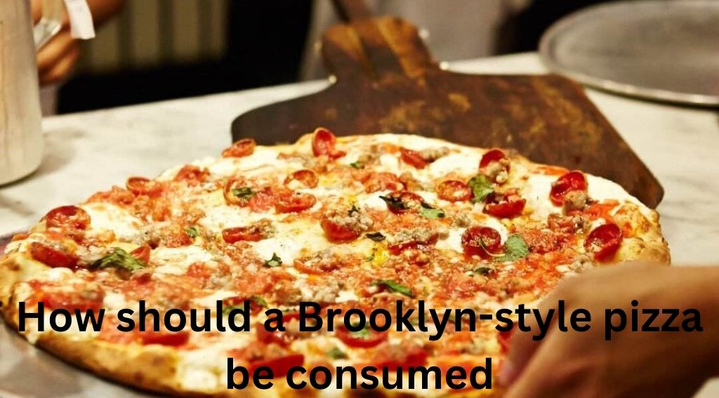 How should a Brooklyn-style pizza be consumed