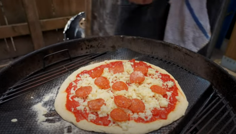 Sliding The Pizza Onto The Oven Or Grill